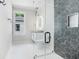 Contemporary bathroom with a glass shower, unique tile work, and modern fixtures at 115 Thome Dr, Alpharetta, GA 30022