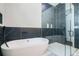 Luxurious bathroom featuring a freestanding tub, glass-enclosed shower, and elegant tile work at 115 Thome Dr, Alpharetta, GA 30022