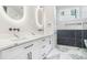 Elegant bathroom featuring dual sinks, marble countertops, and modern fixtures at 115 Thome Dr, Alpharetta, GA 30022