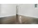 Spacious bedroom with hardwood floors, white trim, and natural light from two windows at 115 Thome Dr, Alpharetta, GA 30022