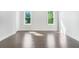 Bright and sunny bedroom with hardwood floors and two large windows at 115 Thome Dr, Alpharetta, GA 30022