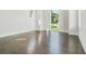 Bright bedroom with hardwood floors and large windows overlooking a picturesque yard at 115 Thome Dr, Alpharetta, GA 30022