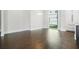 Bright dining room with hardwood floors, white trim, and a large window at 115 Thome Dr, Alpharetta, GA 30022