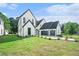 Stunning two-story home boasts a manicured lawn and eye-catching black and white design at 115 Thome Dr, Alpharetta, GA 30022