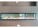 Close up of a linear fireplace with wooden wall accent at 115 Thome Dr, Alpharetta, GA 30022