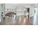 Bright hallway with hardwood flooring, glass railing and natural light at 115 Thome Dr, Alpharetta, GA 30022