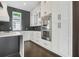 Modern kitchen with stainless steel appliances, granite countertops, and custom cabinetry at 115 Thome Dr, Alpharetta, GA 30022