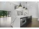 Bright kitchen with a large island, stainless steel appliances and an open floorplan at 115 Thome Dr, Alpharetta, GA 30022