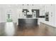 Modern kitchen featuring a large island, stainless steel appliances and a view of the backyard at 115 Thome Dr, Alpharetta, GA 30022