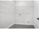 A laundry room with wire shelving and gray tiled floors providing functional storage space at 115 Thome Dr, Alpharetta, GA 30022