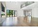 Open concept living room with fireplace, hardwood floors and access to the backyard at 115 Thome Dr, Alpharetta, GA 30022