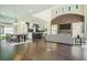 Open concept living room with dining area, modern kitchen, fireplace and great natural light at 115 Thome Dr, Alpharetta, GA 30022