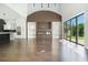 Expansive living space with wood floors, large windows, kitchen, fireplace, and high ceilings at 115 Thome Dr, Alpharetta, GA 30022