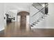 Open living space with dark wood floors, a fireplace feature, and a modern kitchen with white cabinets and black backsplash at 115 Thome Dr, Alpharetta, GA 30022
