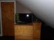 Bedroom with a wooden dresser, television, and charming details in an attic space at 3096 Campground Rd, Winston, GA 30187