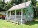 Charming log cabin with a cozy front porch and well-maintained lawn at 3096 Campground Rd, Winston, GA 30187