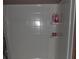 Tiled shower stall with built-in shelving for toiletries and sliding glass door at 3096 Campground Rd, Winston, GA 30187