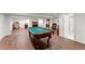 Finished basement with pool table, hardwood floors, entertainment area, and full bathroom at 4161 Thunderbird Se Dr, Marietta, GA 30067