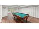 Finished basement featuring a billiard table, wood flooring, and access to the outdoors at 4161 Thunderbird Se Dr, Marietta, GA 30067