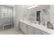 Bathroom featuring gray walls, white cabinets, quartz countertop, and a modern mirror at 4161 Thunderbird Se Dr, Marietta, GA 30067
