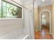 Bright bathroom featuring a whirlpool tub, a stained-glass window, and earth-toned tile flooring at 4161 Thunderbird Se Dr, Marietta, GA 30067