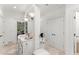 Bright bathroom vanity with white cabinetry, stone floors and countertop, and decorative lighting at 4161 Thunderbird Se Dr, Marietta, GA 30067