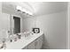 Bright bathroom featuring a large mirror, white vanity, and modern lighting at 4161 Thunderbird Se Dr, Marietta, GA 30067