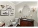 Elegant powder room with a custom vanity, granite counters, and decorative mirror at 4161 Thunderbird Se Dr, Marietta, GA 30067