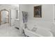 Bathroom with an ornate mirror, bathtub, and a doorway to another room at 4161 Thunderbird Se Dr, Marietta, GA 30067