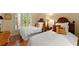 Cozy bedroom with twin beds, palm-themed pillows, and sunlit windows offering a serene retreat at 4161 Thunderbird Se Dr, Marietta, GA 30067