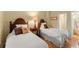 Comfortable bedroom featuring twin beds, decorative pillows, and warm lighting creating a relaxing atmosphere at 4161 Thunderbird Se Dr, Marietta, GA 30067