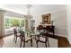 Elegant dining room with hardwood floors, a glass table, and decorative chandelier at 4161 Thunderbird Se Dr, Marietta, GA 30067