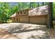 Spacious multi-car garage exterior with large concrete driveway bordered by mature trees and landscaping at 4161 Thunderbird Se Dr, Marietta, GA 30067