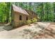 Exterior view of a home with an attached garage and concrete driveway surrounded by lush trees at 4161 Thunderbird Se Dr, Marietta, GA 30067