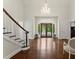Elegant foyer featuring beautiful hardwood floors, a chandelier, and paneled walls at 4161 Thunderbird Se Dr, Marietta, GA 30067