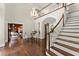 Spacious foyer with hardwood floors, staircase, and elegant chandelier at 4161 Thunderbird Se Dr, Marietta, GA 30067
