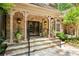 Stone entryway with decorative glass double doors and manicured landscaping creating curb appeal at 4161 Thunderbird Se Dr, Marietta, GA 30067