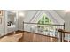 Second floor landing showcasing wood floors, railings, and view of lower level at 4161 Thunderbird Se Dr, Marietta, GA 30067