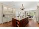 Bright kitchen with a large granite island, breakfast area, and custom white cabinets at 4161 Thunderbird Se Dr, Marietta, GA 30067