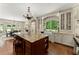 Gourmet kitchen featuring an island, granite countertops, custom cabinets, and a breakfast area at 4161 Thunderbird Se Dr, Marietta, GA 30067