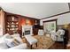 Cozy living room with fireplace, built-in bookshelves, and comfortable seating at 4161 Thunderbird Se Dr, Marietta, GA 30067