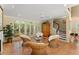 Inviting sunroom with wicker seating, tiled floors, and large windows offering serene views of the surrounding landscape at 4161 Thunderbird Se Dr, Marietta, GA 30067