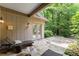 Outdoor patio with stone flooring, chaise lounge, and view of wooded backyard at 4161 Thunderbird Se Dr, Marietta, GA 30067