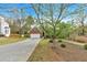 Beautiful brick home with a concrete driveway, manicured landscaping, and mature trees in the front yard at 46 Centerport Dr, White, GA 30184