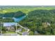 A sprawling property surrounded by lush forest and a glistening lake, offering privacy and stunning natural beauty at 6625 Baywood Run, Cumming, GA 30041