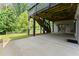 View of walkout basement patio with covered deck, landscaped backyard and fence at 6625 Baywood Run, Cumming, GA 30041
