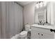 Neutral bathroom featuring a shower with curtain, vanity, toilet, and modern fixtures at 6625 Baywood Run, Cumming, GA 30041