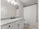 Bright bathroom featuring a white vanity, and a shower-tub combo with a white curtain at 6625 Baywood Run, Cumming, GA 30041