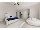 Stylish bedroom featuring a ceiling fan and a comfortable seating area at 6625 Baywood Run, Cumming, GA 30041