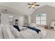 Cozy bedroom featuring vaulted ceilings, a ceiling fan, and ample closet space at 6625 Baywood Run, Cumming, GA 30041